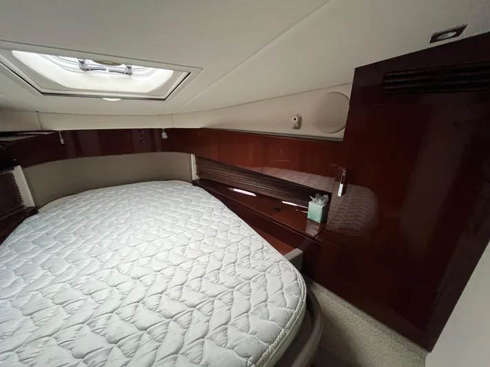 Feeling Nauti Yacht Photos Pics Interior cabin of 2011 Sea Ray 470 Sundancer with bed and wooden cabinetry.