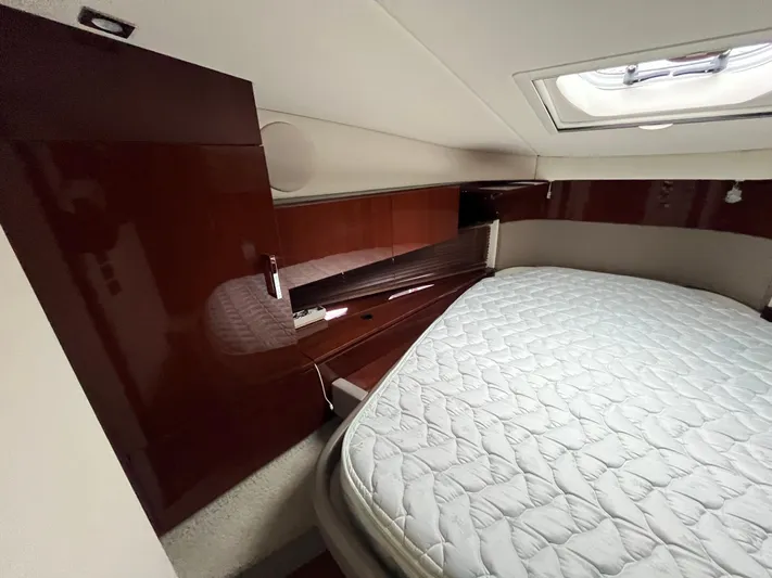 Feeling Nauti Yacht Photos Pics Interior cabin of 2011 Sea Ray 470 Sundancer with bed and wooden cabinetry.
