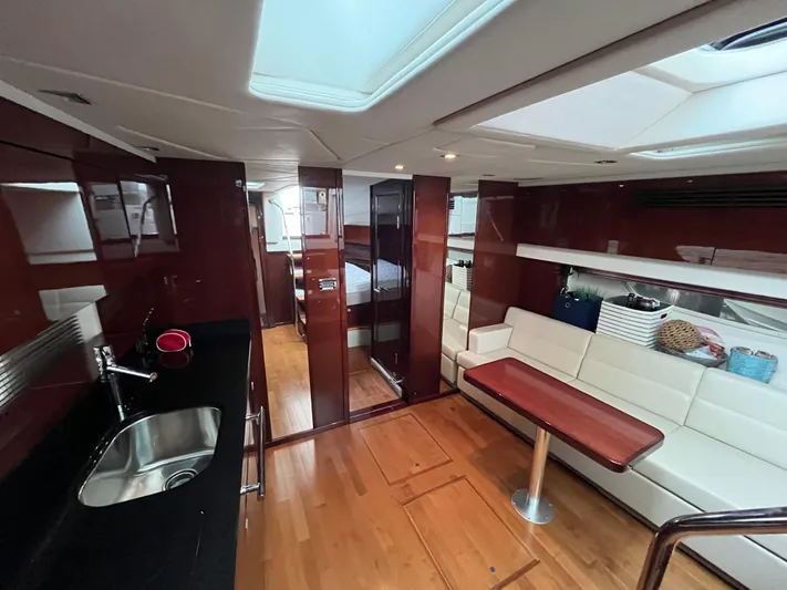 Feeling Nauti Yacht Photos Pics Luxurious interior of 2011 Sea Ray 470 Sundancer yacht with modern kitchen and seating area.