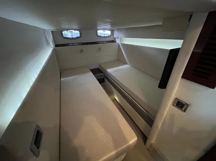 Feeling Nauti Yacht Photos Pics 2011 Sea Ray 470 Sundancer cabin interior with twin beds and porthole windows.