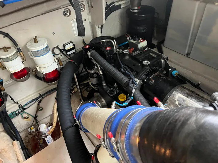 Feeling Nauti Yacht Photos Pics Engine room of 2011 Sea Ray 470 Sundancer, showcasing mechanical components and hoses.