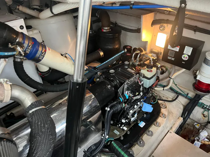 Feeling Nauti Yacht Photos Pics Engine room of a 2011 Sea Ray 470 Sundancer, showcasing mechanical components and wiring.