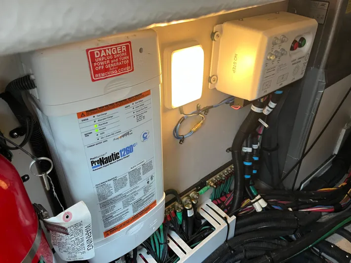 Feeling Nauti Yacht Photos Pics Engine room of 2011 Sea Ray 470 Sundancer with electrical components and warning labels.