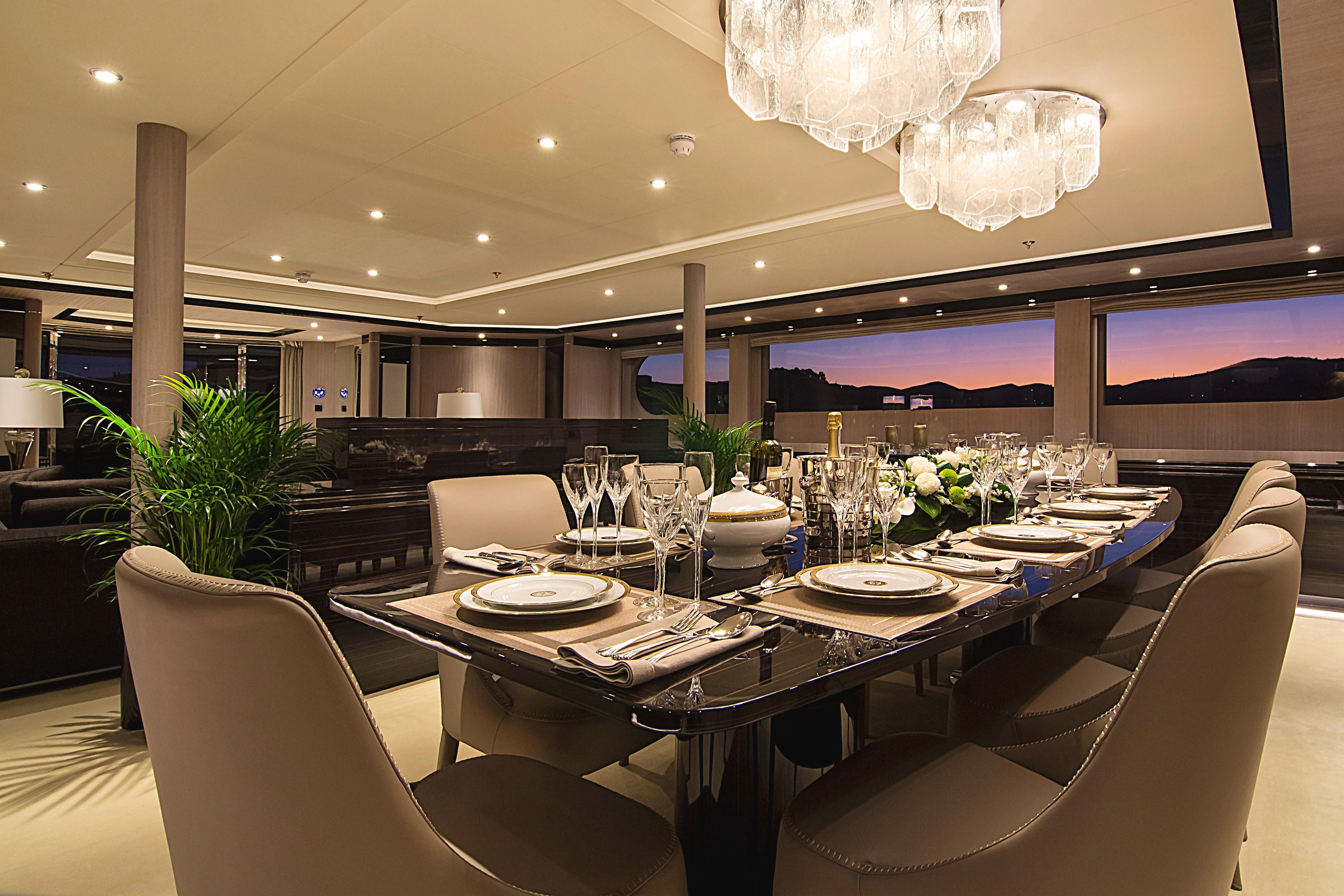 Luxurious dining area on 1999 Codecasa 50m Motoryacht, elegantly set for an evening meal.