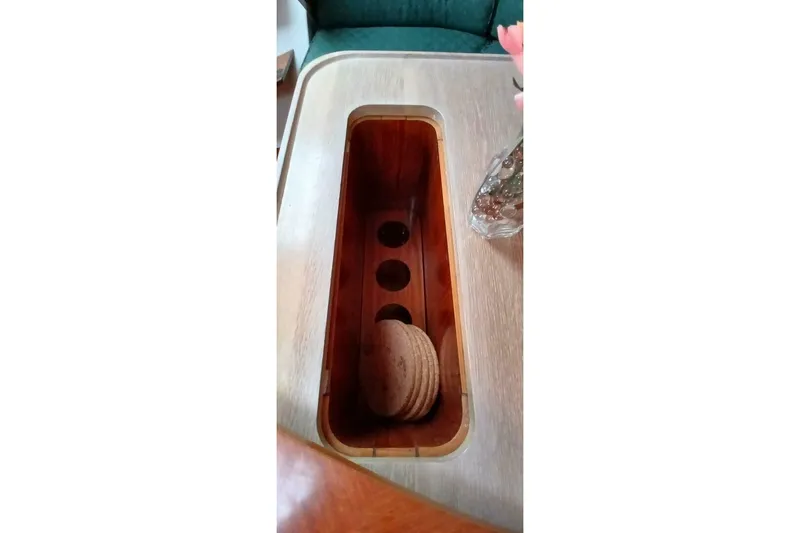 Waterfall II Yacht Photos Pics Wooden table with built-in storage on a 1994 Beneteau Oceanis 44 CC yacht.