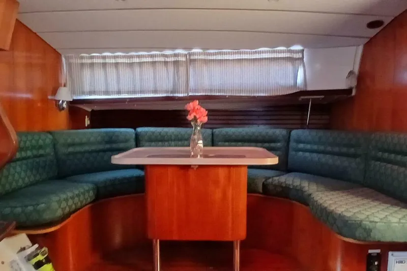 Waterfall II Yacht Photos Pics Interior of 1994 Beneteau Oceanis 44 CC yacht with cozy seating and table.