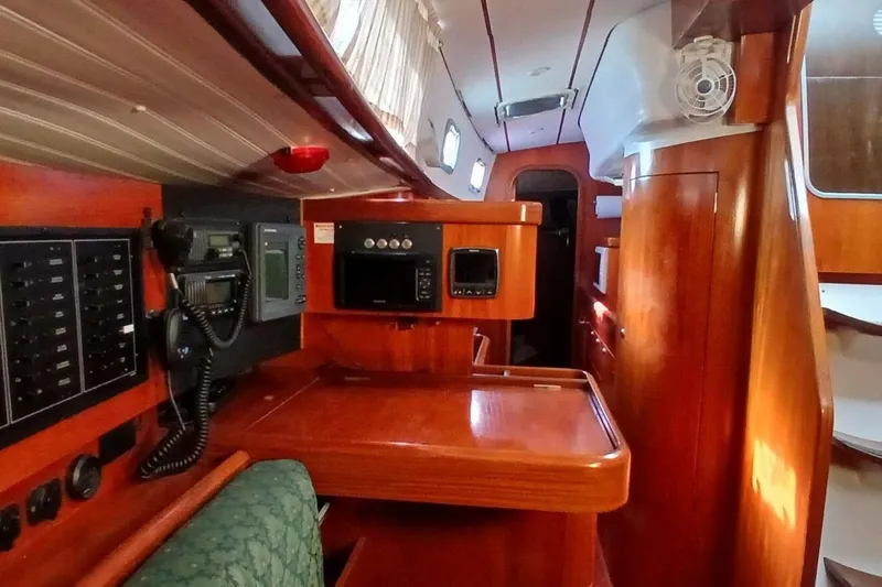 Waterfall II Yacht Photos Pics Interior of 1994 Beneteau Oceanis 44 CC sailboat with wooden cabinetry and navigation equipment.