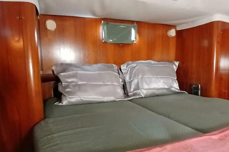 Waterfall II Yacht Photos Pics Cozy cabin interior of 1994 Beneteau Oceanis 44 CC with wooden paneling and comfortable bedding.