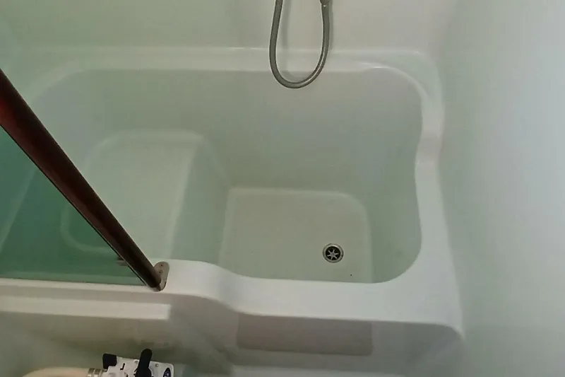 Waterfall II Yacht Photos Pics Shower area in 1994 Beneteau Oceanis 44 CC yacht, featuring a clean, white design.