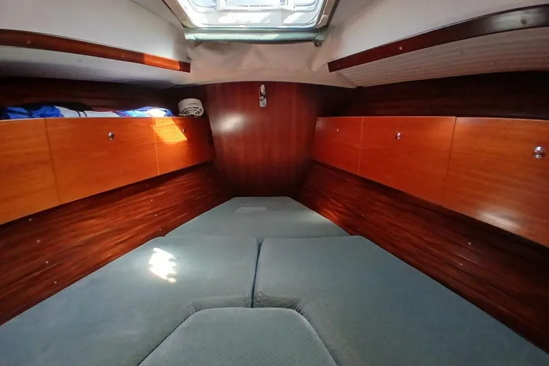 Waterfall II Yacht Photos Pics Cozy cabin interior of 1994 Beneteau Oceanis 44 CC sailboat with wooden storage cabinets.