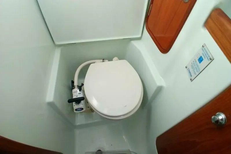 Waterfall II Yacht Photos Pics 1994 Beneteau Oceanis 44 CC yacht bathroom with marine toilet and wooden accents.