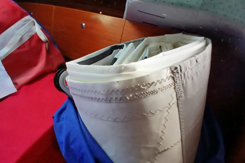 Waterfall II Yacht Photos Pics Folded sail inside Beneteau Oceanis 44 CC, 1994 model, with red and blue fabric nearby.