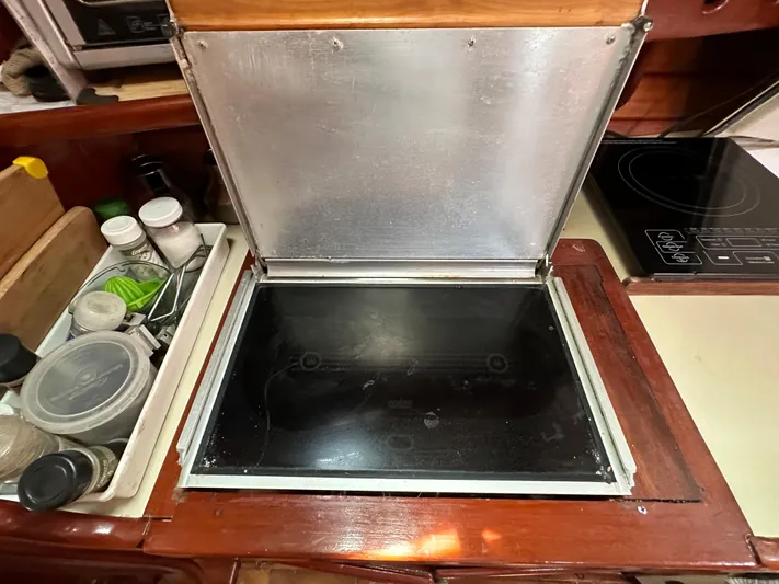 Interlude X Yacht Photos Pics Open stove compartment on 1985 Thomas Colvin "Pipistrelle" boat with spice rack nearby.