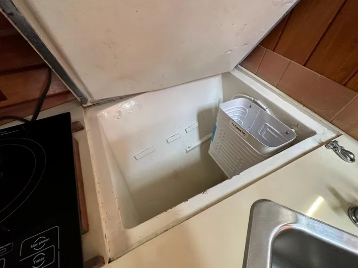 Interlude X Yacht Photos Pics Open storage compartment on 1985 Thomas Colvin "Pipistrelle" boat with white container inside.