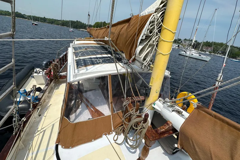 Interlude X Yacht Photos Pics 1985 Custom Thomas Colvin "Pipistrelle" sailboat on water, featuring brown sails and deck.