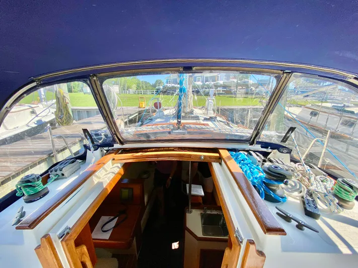 Encore Yacht Photos Pics 1998 Pacific Seacraft 37 sailboat cockpit view with open cabin and deck equipment.