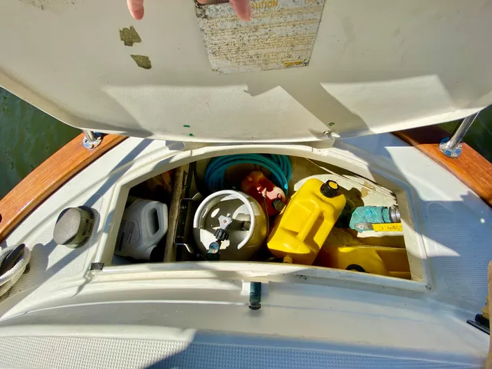 Encore Yacht Photos Pics Storage compartment on a 1998 Pacific Seacraft 37 sailboat with various equipment and supplies.