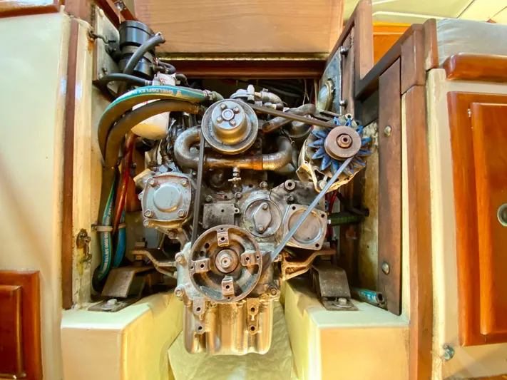 Encore Yacht Photos Pics Engine compartment of a 1998 Pacific Seacraft 37 sailboat, showcasing mechanical components.