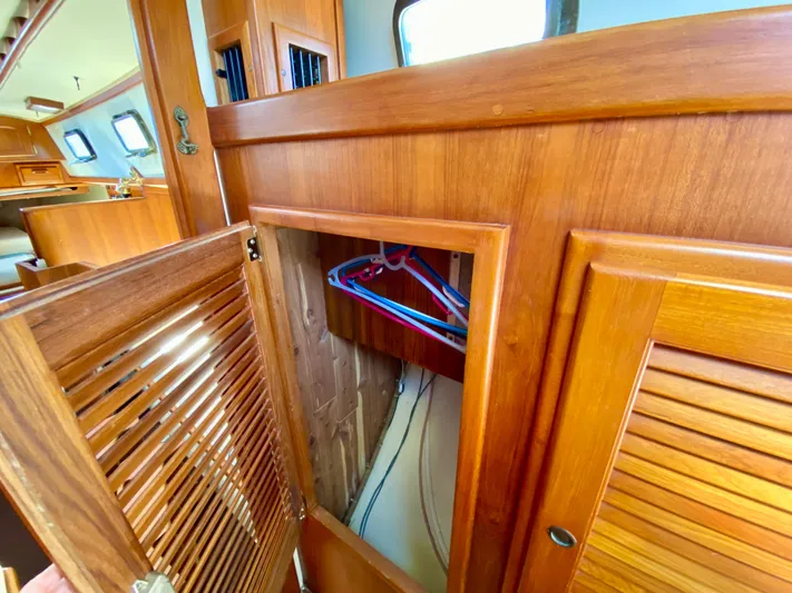 Encore Yacht Photos Pics Interior of 1998 Pacific Seacraft 37 sailboat with wooden cabinetry and closet.