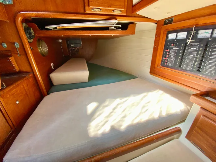 Encore Yacht Photos Pics Interior cabin of 1998 Pacific Seacraft 37 sailboat with wooden finish and control panel.