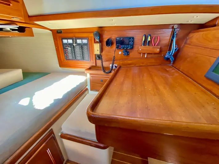 Encore Yacht Photos Pics Navigation station in 1998 Pacific Seacraft 37 sailboat with control panel and tools.
