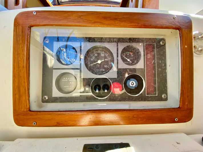 Encore Yacht Photos Pics Control panel of a 1998 Pacific Seacraft 37 sailboat with wooden frame.