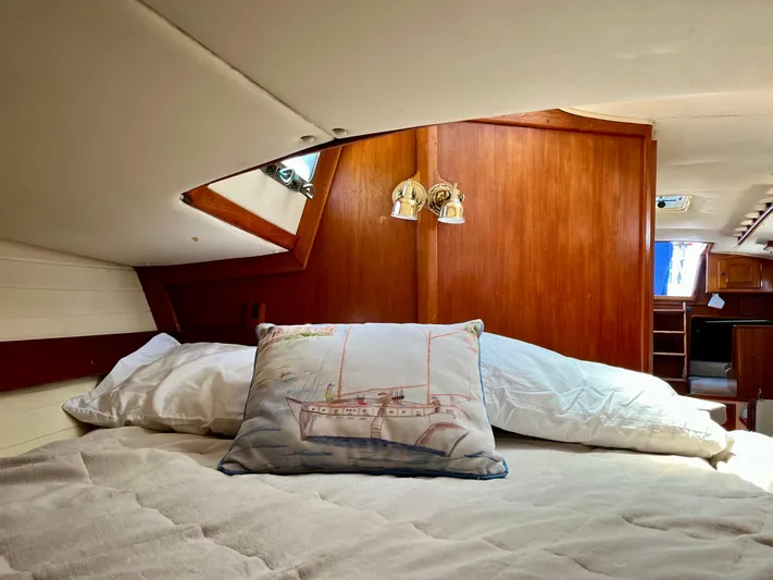 Encore Yacht Photos Pics Cozy cabin interior of 1998 Pacific Seacraft 37 sailboat with nautical-themed pillow.
