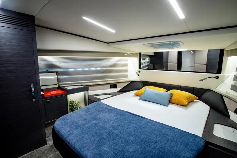  Yacht Photos Pics Luxurious bedroom interior of 2025 Cobrey 45 FLY yacht with modern design and cozy bedding.