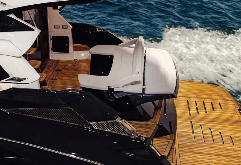  Yacht Photos Pics Luxurious 2025 Cobrey 45 FLY yacht with sleek design and wooden deck on open water.