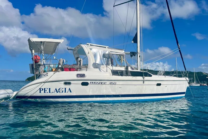 Pelagia Yacht Photos Pics Hunter Passage 450 sailboat from 1998 on calm blue waters under a clear sky.