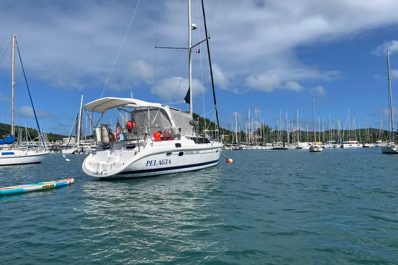 Pelagia Yacht Photos Pics Hunter Passage 450 sailboat from 1998 docked in a marina under a clear blue sky.
