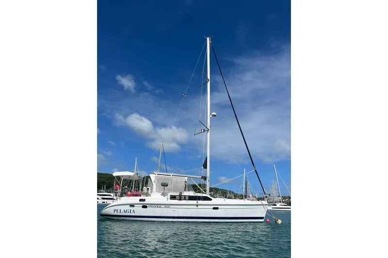 Pelagia Yacht Photos Pics Sailboat "Pelagia" on water, 1998 Hunter Passage 450, clear blue sky background.