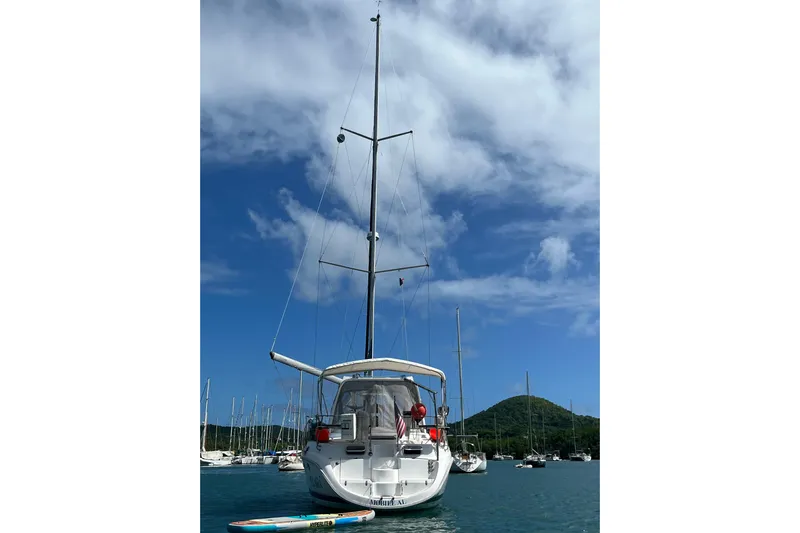 Pelagia Yacht Photos Pics Sailboat Hunter Passage 450, 1998 model, anchored in scenic bay with clear skies.