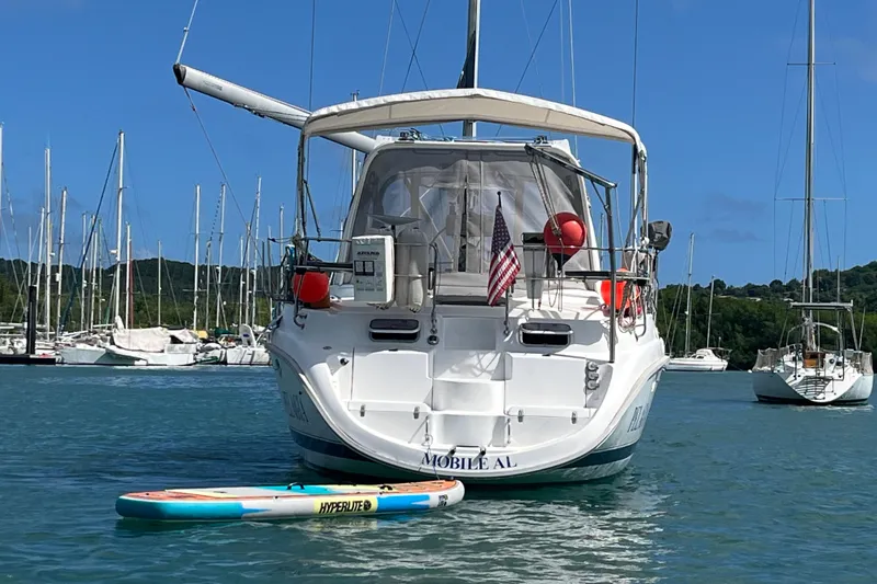Pelagia Yacht Photos Pics Hunter Passage 450 sailboat from 1998 docked with paddleboard, marina background.
