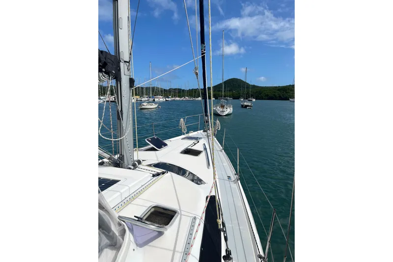Pelagia Yacht Photos Pics Sailboat Hunter Passage 450, 1998 model, anchored in scenic bay with clear blue sky.