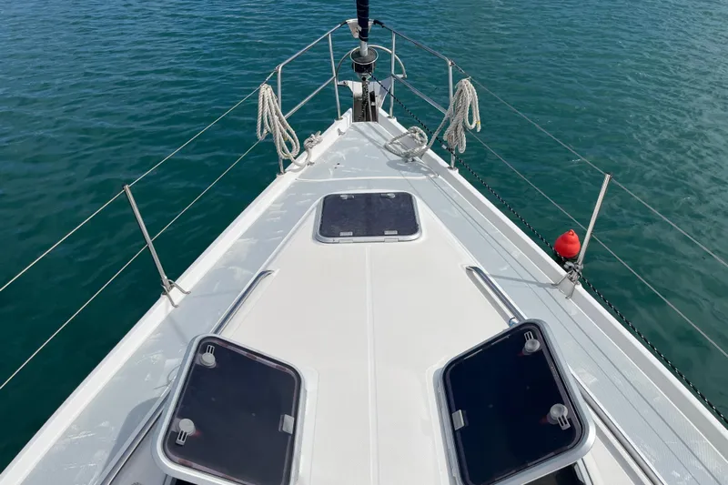 Pelagia Yacht Photos Pics Deck view of 1998 Hunter Passage 450 sailboat on calm blue water.