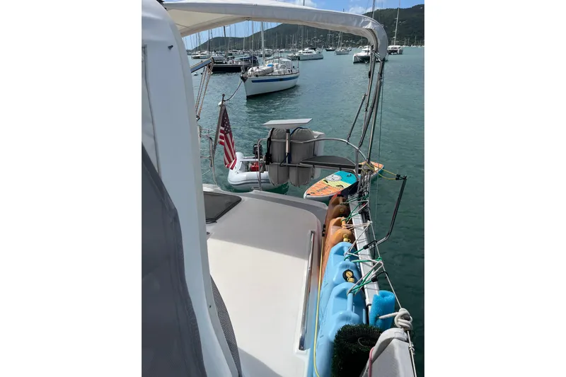 Pelagia Yacht Photos Pics Hunter Passage 450 sailboat, 1998 model, docked in a serene marina with paddleboard.