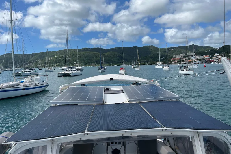 Pelagia Yacht Photos Pics Hunter Passage 450 sailboat with solar panels in a scenic marina, 1998 model.