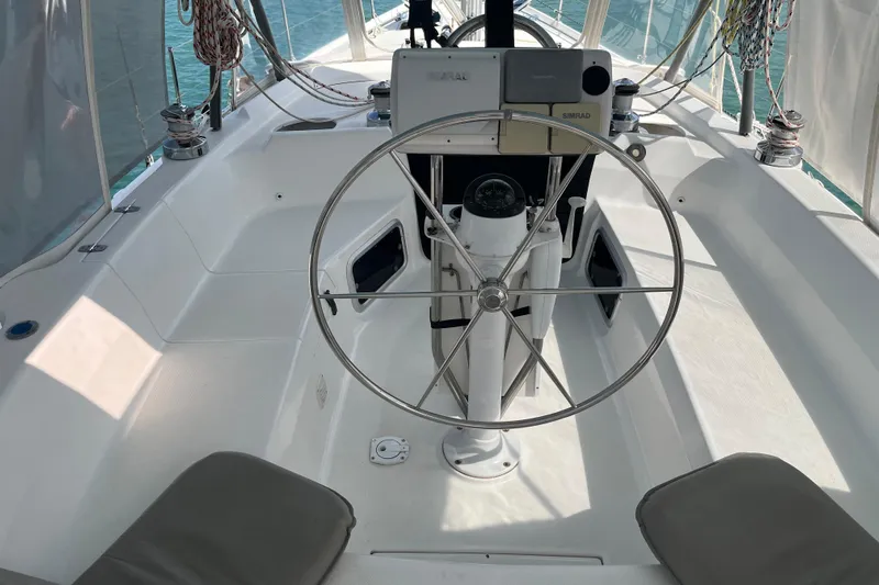 Pelagia Yacht Photos Pics Cockpit of 1998 Hunter Passage 450 sailboat with steering wheel and navigation equipment.