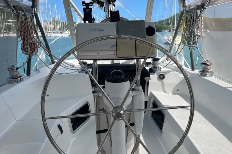 Pelagia Yacht Photos Pics Cockpit of 1998 Hunter Passage 450 sailboat with steering wheel and navigation equipment.