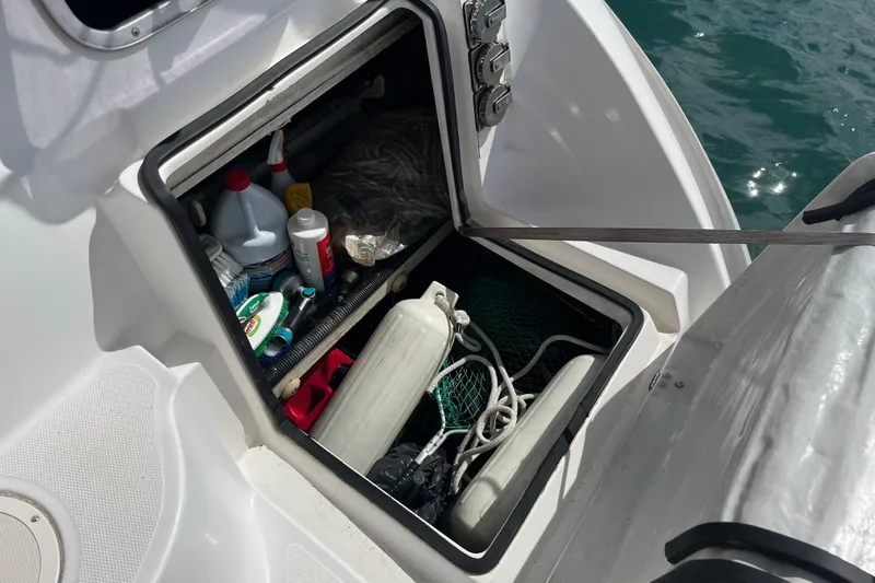 Pelagia Yacht Photos Pics Open storage compartment on 1998 Hunter Passage 450 sailboat, containing various supplies and equipment.