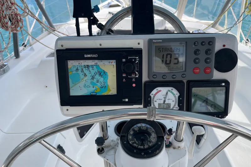 Pelagia Yacht Photos Pics Navigation instruments on a 1998 Hunter Passage 450 sailboat, featuring Simrad and Raymarine displays.