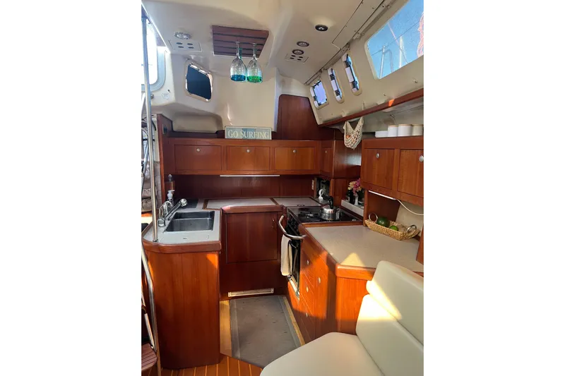 Pelagia Yacht Photos Pics Interior of 1998 Hunter Passage 450 yacht with wooden cabinetry and modern kitchen amenities.