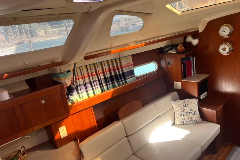 Pelagia Yacht Photos Pics Interior of 1998 Hunter Passage 450 sailboat with cozy seating and nautical decor.