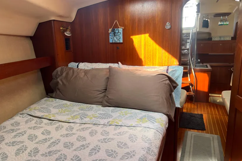 Pelagia Yacht Photos Pics Cozy cabin interior of 1998 Hunter Passage 450 sailboat with bed and wooden finish.