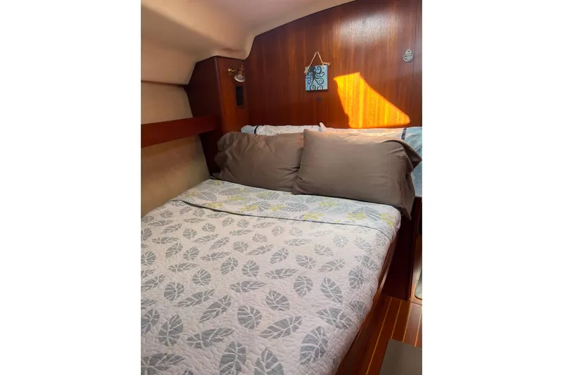 Pelagia Yacht Photos Pics Cozy cabin interior of 1998 Hunter Passage 450 sailboat with patterned bedding.