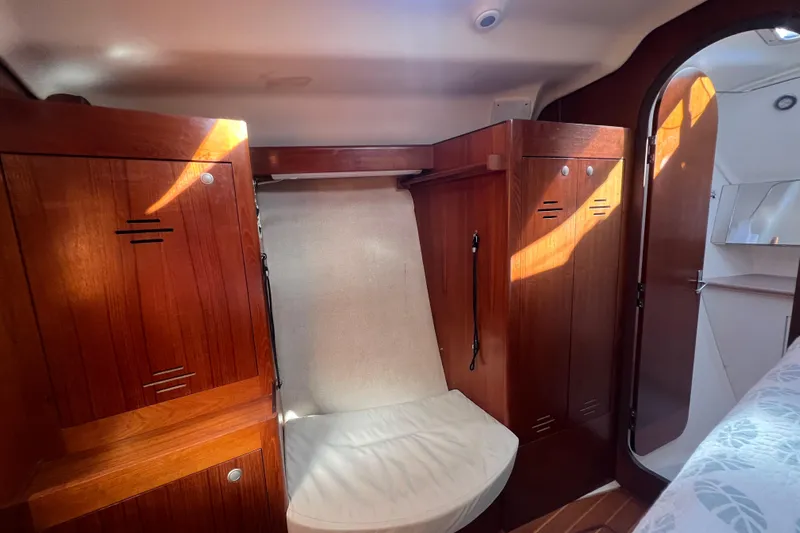 Pelagia Yacht Photos Pics Interior of 1998 Hunter Passage 450 yacht with wooden cabinets and seating area.