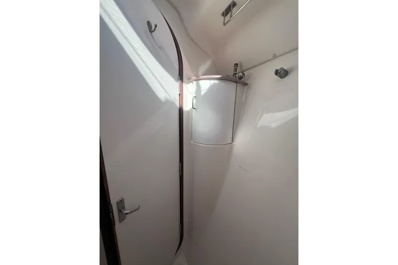 Pelagia Yacht Photos Pics 1998 Hunter Passage 450 yacht bathroom with compact sink and white interior.