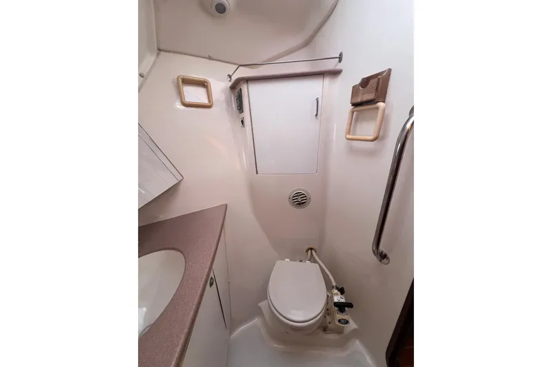 Pelagia Yacht Photos Pics 1998 Hunter Passage 450 yacht bathroom with toilet, sink, and storage cabinet.