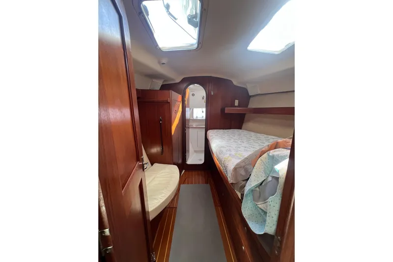 Pelagia Yacht Photos Pics 1998 Hunter Passage 450 yacht interior with wooden finish and cozy sleeping area.